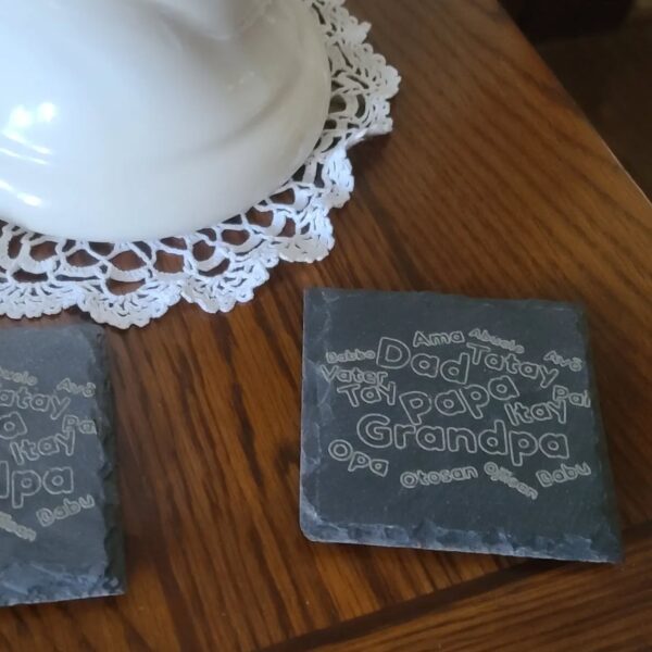 Engraved slate coaster gift for Grandpa with a word cloud in multiple languages.